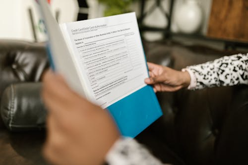 Person reviewing a printed SOP as part of the document management lifecycle.