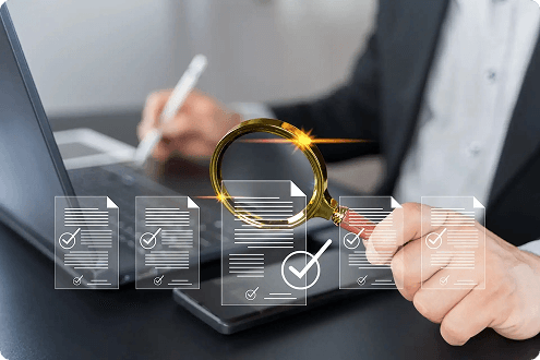 A person in a suit writes on a laptop, overlayed by digital check-marked documents and a magnifying glass, symbolizing data review and analysis.