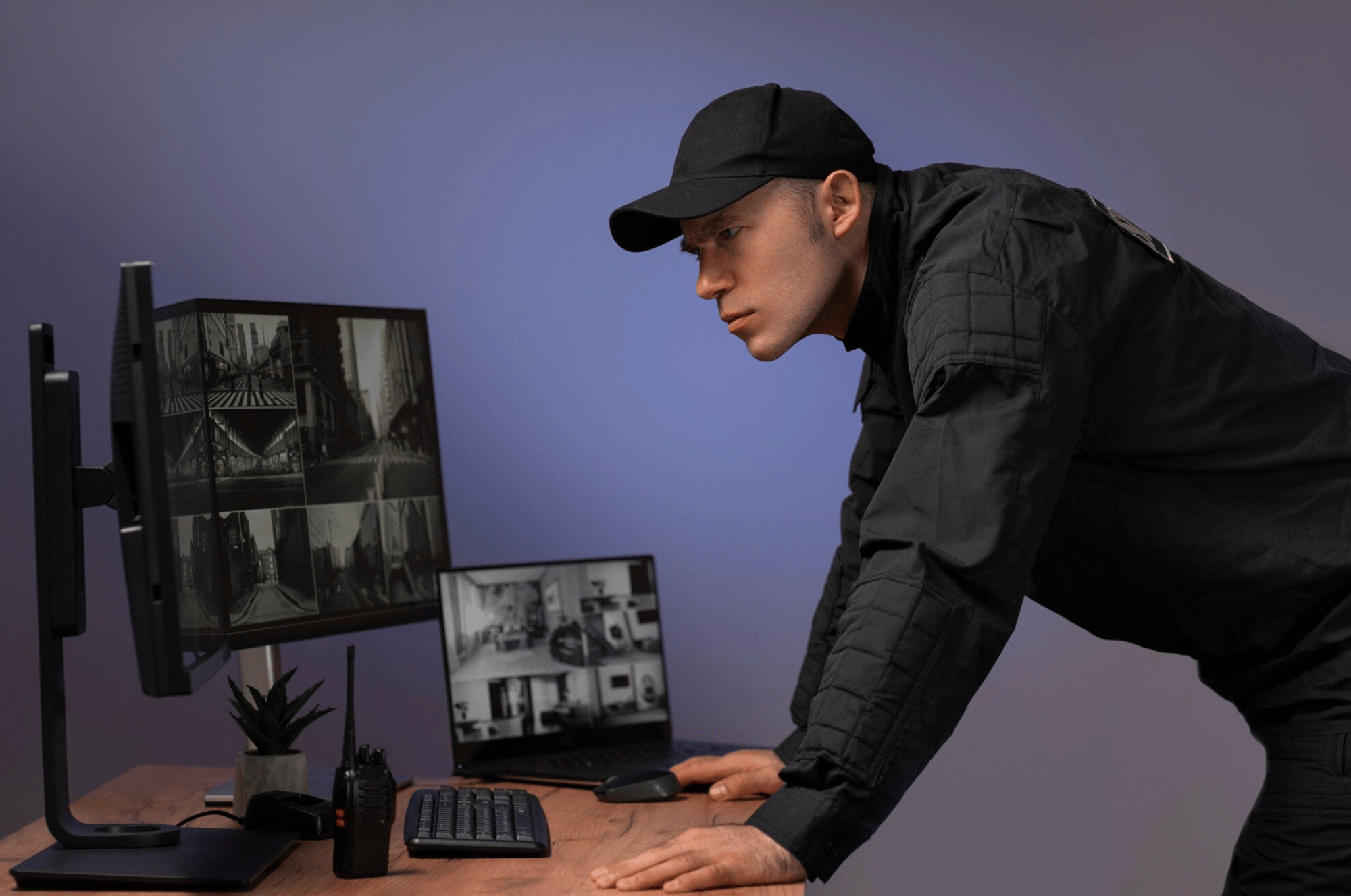 A security guard in black uniform leans over a desk, intently watching surveillance monitors showing grayscale footage. The scene is focused and vigilant. A security guard in black uniform leans over a desk, intently watching surveillance monitors showing grayscale footage. The scene is focused and vigilant.