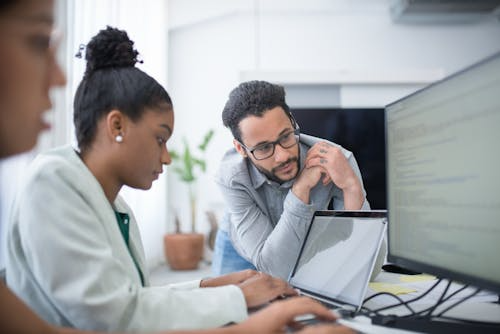 Healthcare professionals collaborating on training records using a healthcare learning management system designed to ensure compliance and reduce administrative workload.