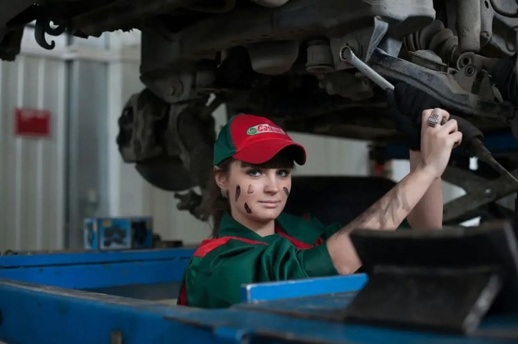 Female worker in a manufacturing firm highlighting the need for compliance training and safety protocols to meet industry regulations.